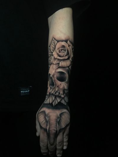 Stunning black and gray realism tattoo featuring an elephant, skull, and rose, expertly done by Jess.
