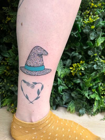 Get mesmerized by Rachel Angharad's enchanting tattoo featuring a witch and wizard in neo traditional style on your lower leg.