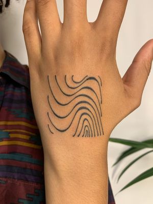 Hand poke tattoo by Dan Bramfitt featuring wavy, abstract lines motif for a unique and artistic look.