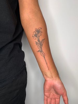 Get a delicate flower design by tattoo artist Dan Bramfitt for a stunning forearm piece. #fine line #floral #tattooart