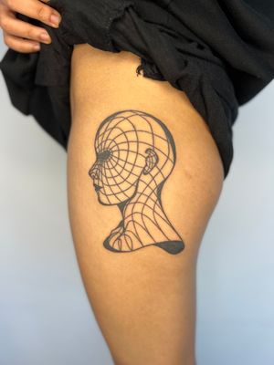 Unique illustrative tattoo featuring a grid pattern with a wireframe head design by artist Dan Bramfitt aka Danyul.