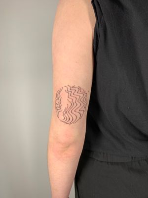 Elegant fine line tattoo by Dan Bramfitt, featuring wavy lines and abstract flow design.