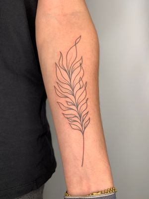 Fine line tattoo featuring a realistic branch with intricate plants and leaves by Dan Bramfitt aka Danyul.