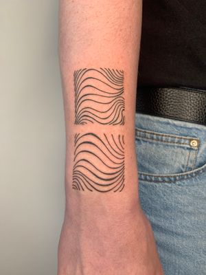 Experience the beauty of fine line and illustrative style with this mesmerizing tattoo of flowing, wavy lines by Dan Bramfitt.