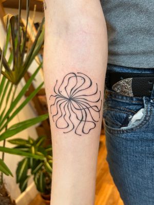 Elegant and intricate fine line tattoo by Dan Bramfitt, featuring beautiful flowing wavy lines. 