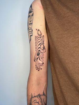 Experience the intricate beauty of freehand wavy lines in this stunning blackwork tattoo by artist Dan Bramfitt, also known as Danyul.
