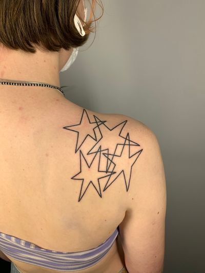 Fine line illustrative star tattoo by Dan Bramfitt (Danyul), showcasing a unique and edgy design.