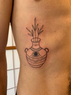 Illustrative tattoo featuring a vase and evil eye design, done by Dan Bramfitt aka Danyul.