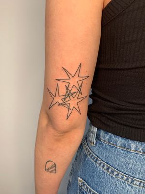 Fine line and illustrative star tattoos by the talented artist Dan Bramfitt, also known as Danyul.