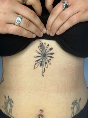 Unique dotwork style tattoo by Dan Bramfitt. Features abstract flower design.