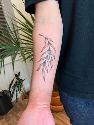 Get a unique and illustrative hand-poke tattoo of a branch done by the talented artist Danyul. Stand out with this beautiful design!