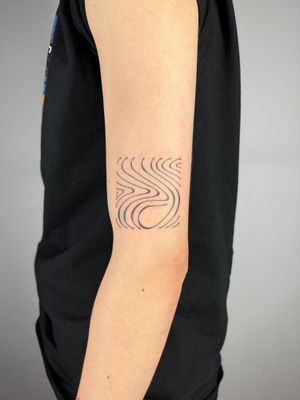 A stunning fine-line tattoo by Dan Bramfitt, featuring wavy and abstract lines that create a beautiful flowing design.