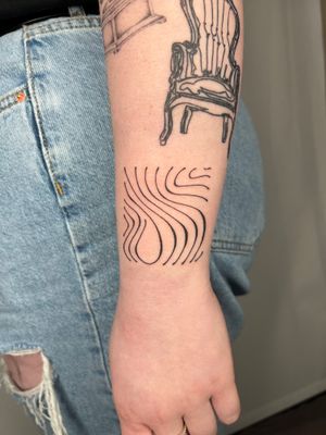 Discover the intricate patterns and wavy lines of this fine line tattoo by the talented artist Dan Bramfitt.