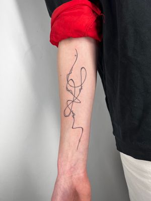 Elegant and flowing wavy lines create a unique abstract design in this fine line tattoo by artist Dan Bramfitt, also known as Danyul.