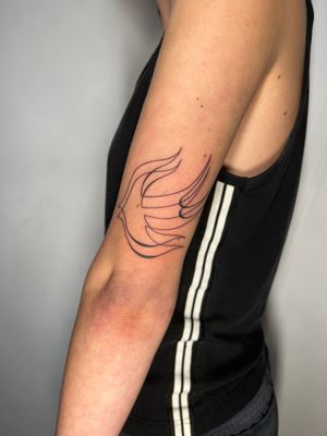 Fine line swallow tattoo by artist Dan Bramfitt, featuring a simple and elegant dove design.
