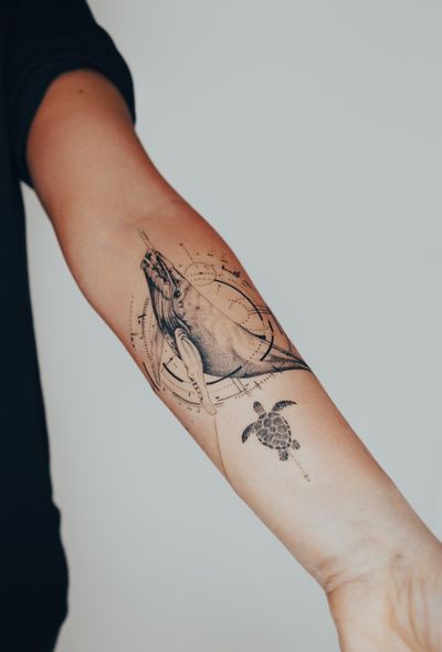 Stunning lower arm tattoo featuring a detailed whale and sea turtle design by Gabriele Edu. Dive into the depths of the ocean with this intricate piece of art.