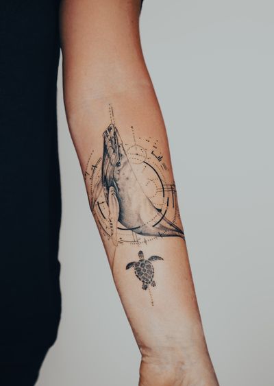 Exquisite fine line and micro-realism tattoo of a whale and sea turtle by Gabriele Edu, perfect for nature lovers.
