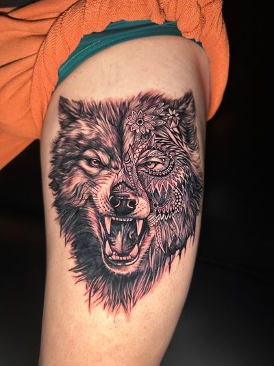 Get a striking tribal wolf tattoo in illustrative black and gray style, expertly crafted by tattoo artist Avi.