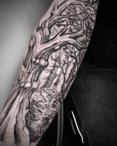 Experience the beauty of nature with this striking blackwork tree tattoo by artist Helena Velazquez. A whimsical forest sketch brought to life on your skin.