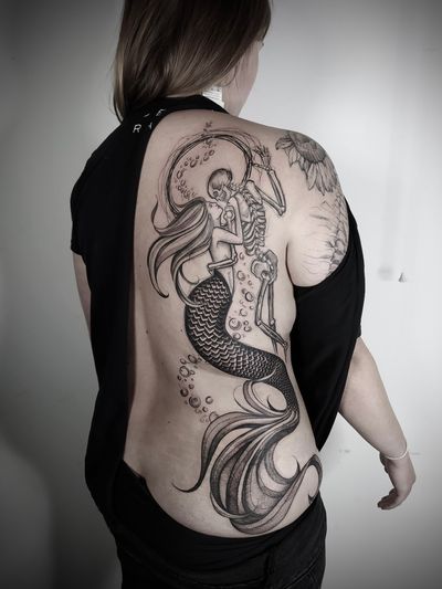 Experience the enchanting fusion of blackwork, dotwork, and illustrative styles in this captivating mermaid skeleton sketch by Helena Velazquez.