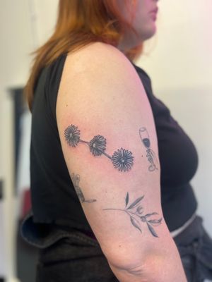 Elegant single line daisy tattoo by Well Good Mate, perfect for a subtle floral touch.