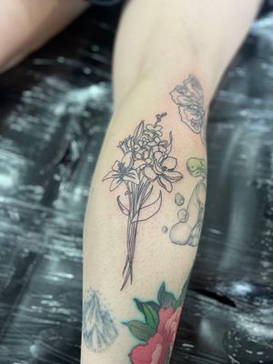 Elegantly designed single line flower tattoo by Well Good Mate, showcasing fine line style.