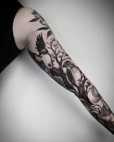 Stunning blackwork tattoo by Helena Velazquez featuring a bird, sakura flower, and tree branch design.