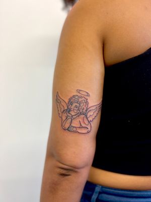 Get inked with a delicate single-line cherub design by Well Good Mate, creating a heavenly touch to your skin.