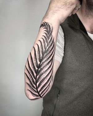 Capture the intricate beauty of nature with this blackwork fern tattoo by Helena Velazquez. Bold and illustrative, this design is a standout piece.