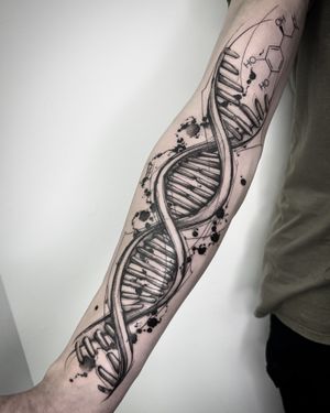 Explore the intricate world of genetics with this unique blackwork tattoo by Helena Velazquez. Combining geometric shapes and watercolor elements, this piece is truly one-of-a-kind.