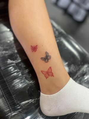 Add a pop of red to your body art with this intricate fine line butterfly tattoo by Well Good Mate. Perfect for those who love delicate designs.