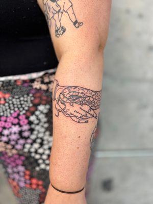 Get a unique and stylish fine line tattoo featuring a snake wrapped around a hand in a single continuous line, done by the talented artist Well Good Mate.