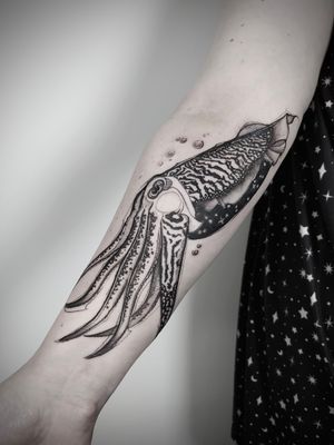 Embrace the mysterious beauty of the deep sea with this stunning blackwork sketch tattoo featuring a mesmerizing cuttlefish design, masterfully created by artist Helena Velazquez.