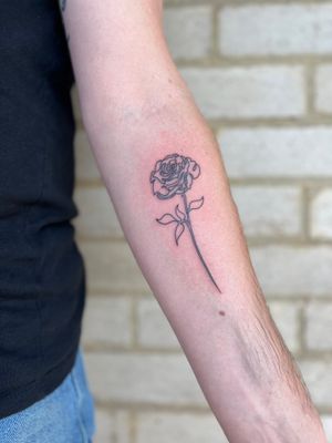 Discover the beauty of a single line fine line rose tattoo by the talented artist Well Good Mate. A minimalist yet striking design.