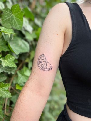 Get zesty with this unique lemon tattoo by Well Good Mate on your upper arm. Stand out with this juicy design!