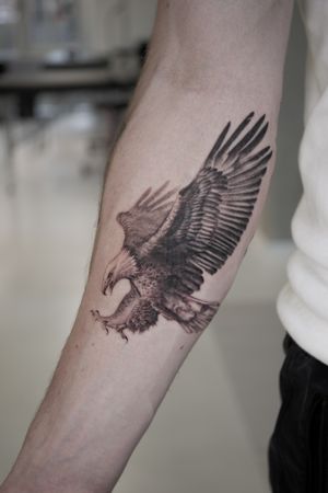 Wings spread eagle on the inside forearm