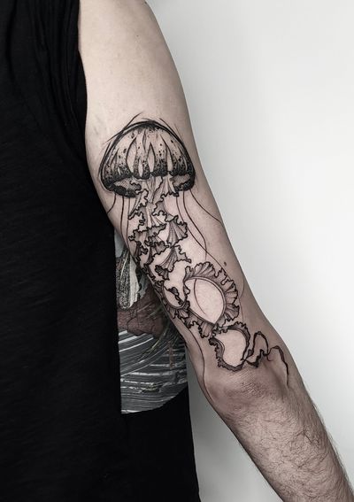 Discover the mesmerizing beauty of a dotwork jellyfish tattoo rendered in an illustrative style by tattoo artist Helena Velazquez.