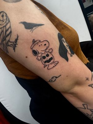 Get an adorable and unique anime style Snoopy tattoo done by the talented artist Miss Vampira, perfect for any Peanuts fan.