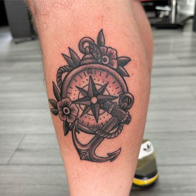 Get inked by Joni Smith with this classic traditional tattoo featuring an anchor and compass design.
