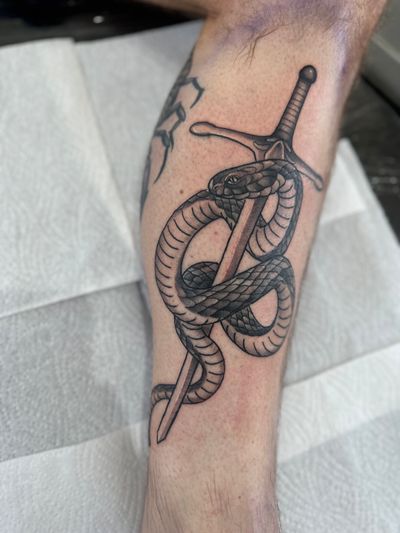 Impressive neo-traditional illustrative design by Joni Smith featuring a striking combination of a snake and sword motif.