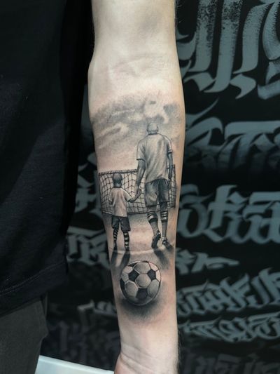 Capture the special connection between father and son with this black and gray illustrative tattoo by Joni Smith.