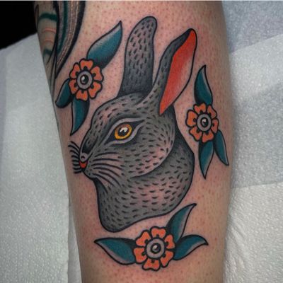 Get inked by Sam Young with a classic rabbit design on your lower leg, executed in a traditional style.