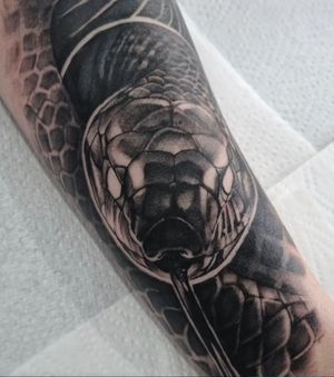 Get mesmerized by this black and gray snake tattoo, expertly crafted by Joni Smith. A stunning piece of art!