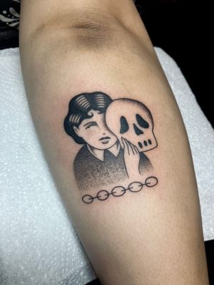 Unique dotwork traditional tattoo featuring a skull, woman, and mask motif by Rachel Arfin.