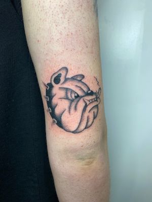 Get a unique illustrative tattoo of a bulldog by the talented artist Charlie Macarthur. Perfect for dog lovers!