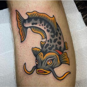 Experience the artistry of Sam Young with this vibrant Japanese koi fish tattoo beautifully inked on the lower leg.