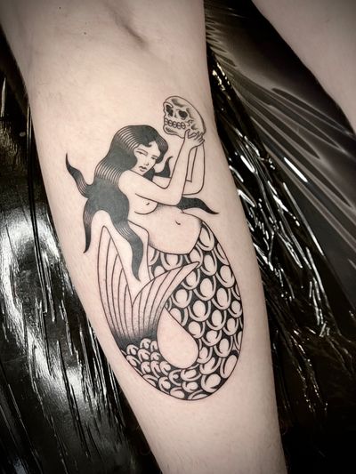 Experience the allure of the sea with this illustrative mermaid tattoo designed by the talented artist, Rachel Arfin.