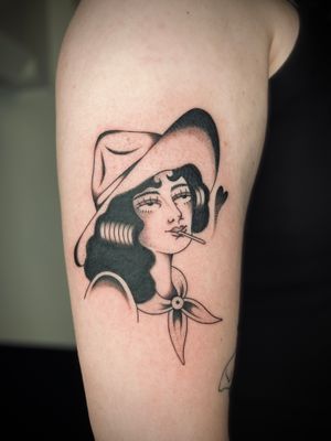 Get a classic cowgirl-inspired tattoo with bold lines and vibrant colors, expertly done by Rachel Arfin in traditional style.