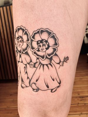 Beautiful traditional style tattoo featuring flowers and kids, artfully designed by Rachel Arfin.