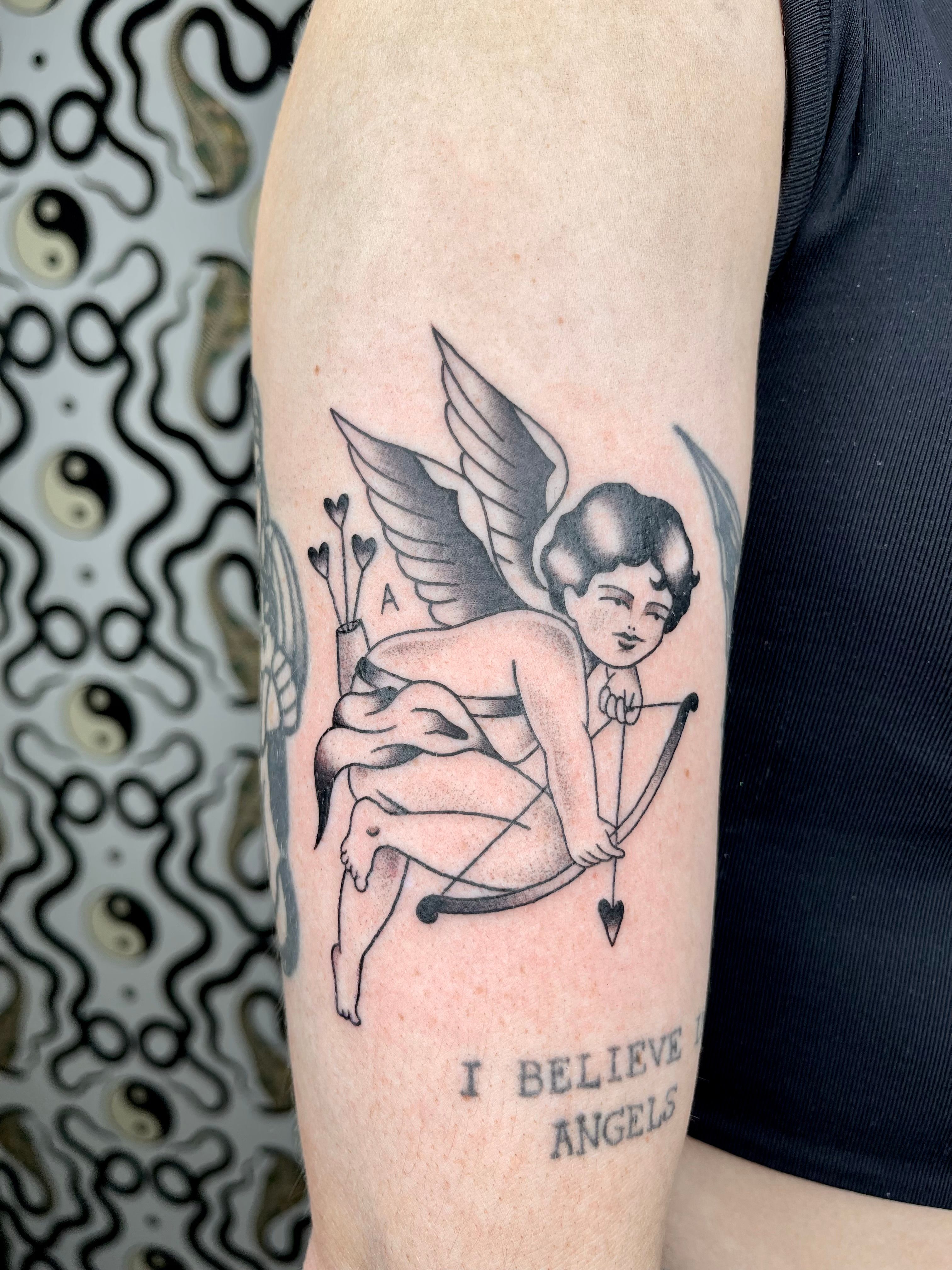 Micro-realistic style Cupid tattoo located on the inner
